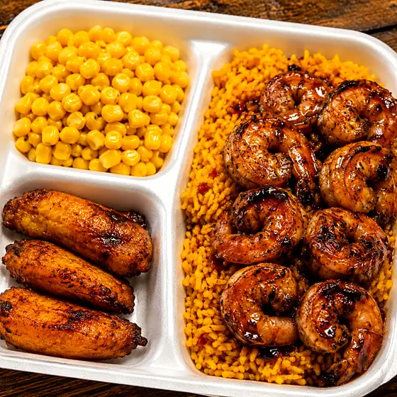 Jerk Shrimp Plate — grilled jumbo shrimp with jerk BBQ sauce, yellow rice, plantains and corn.